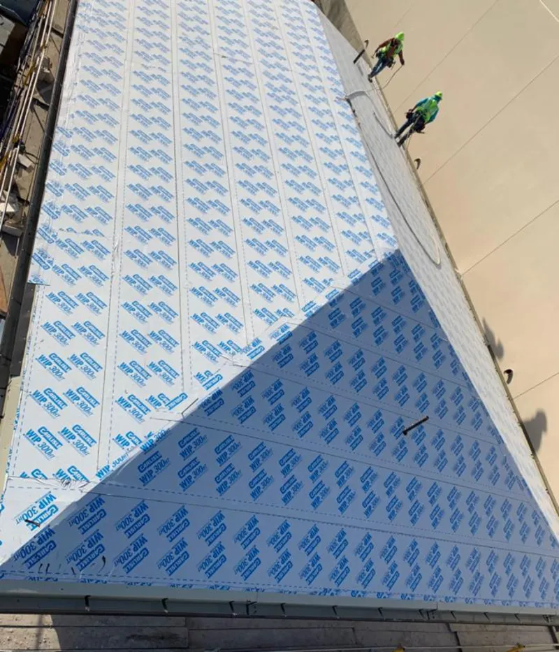 Professional roofers installing underlayment on a metal roof in Hartford